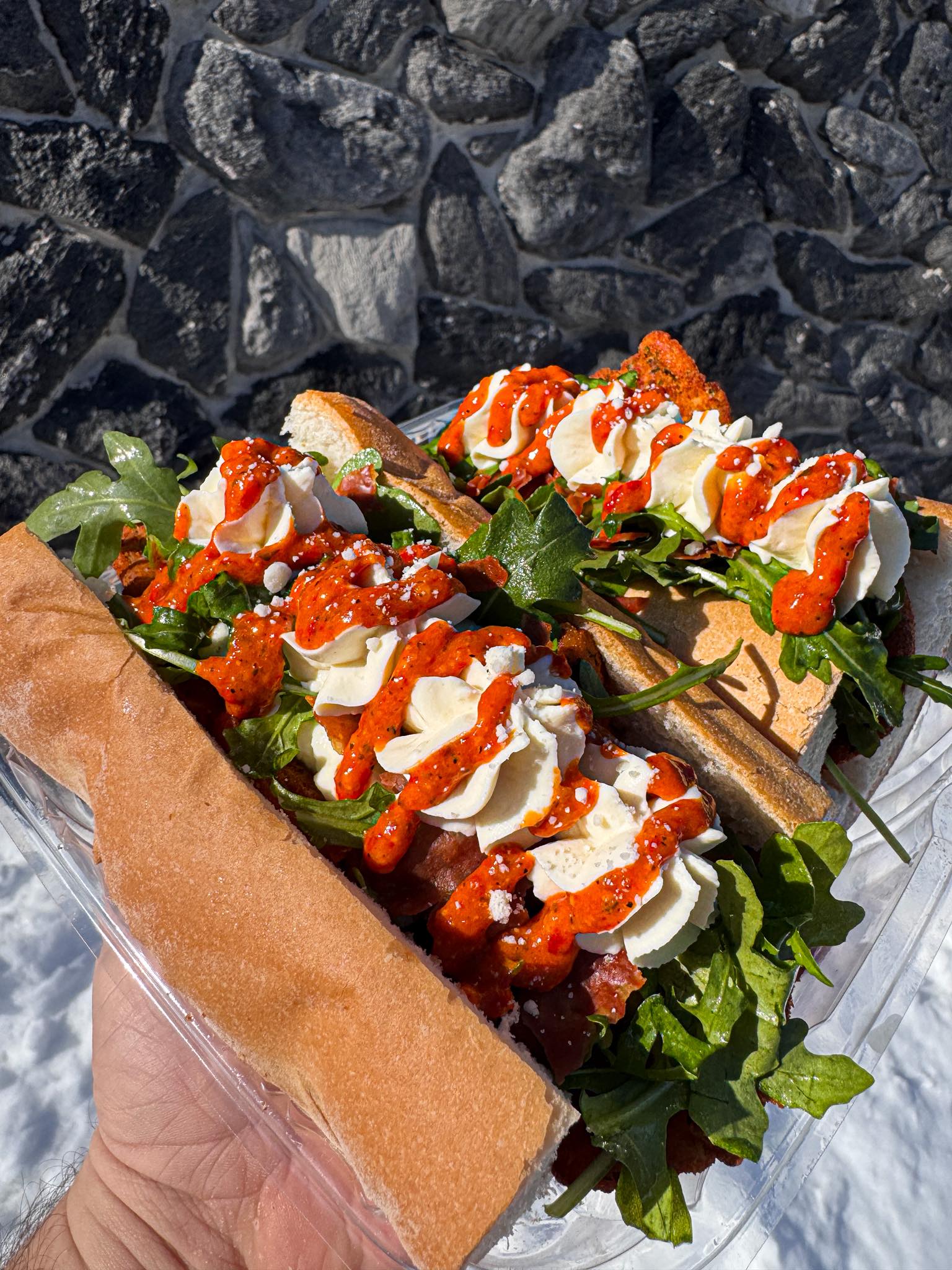 Italian deli sandwich with greens cheese and sauce