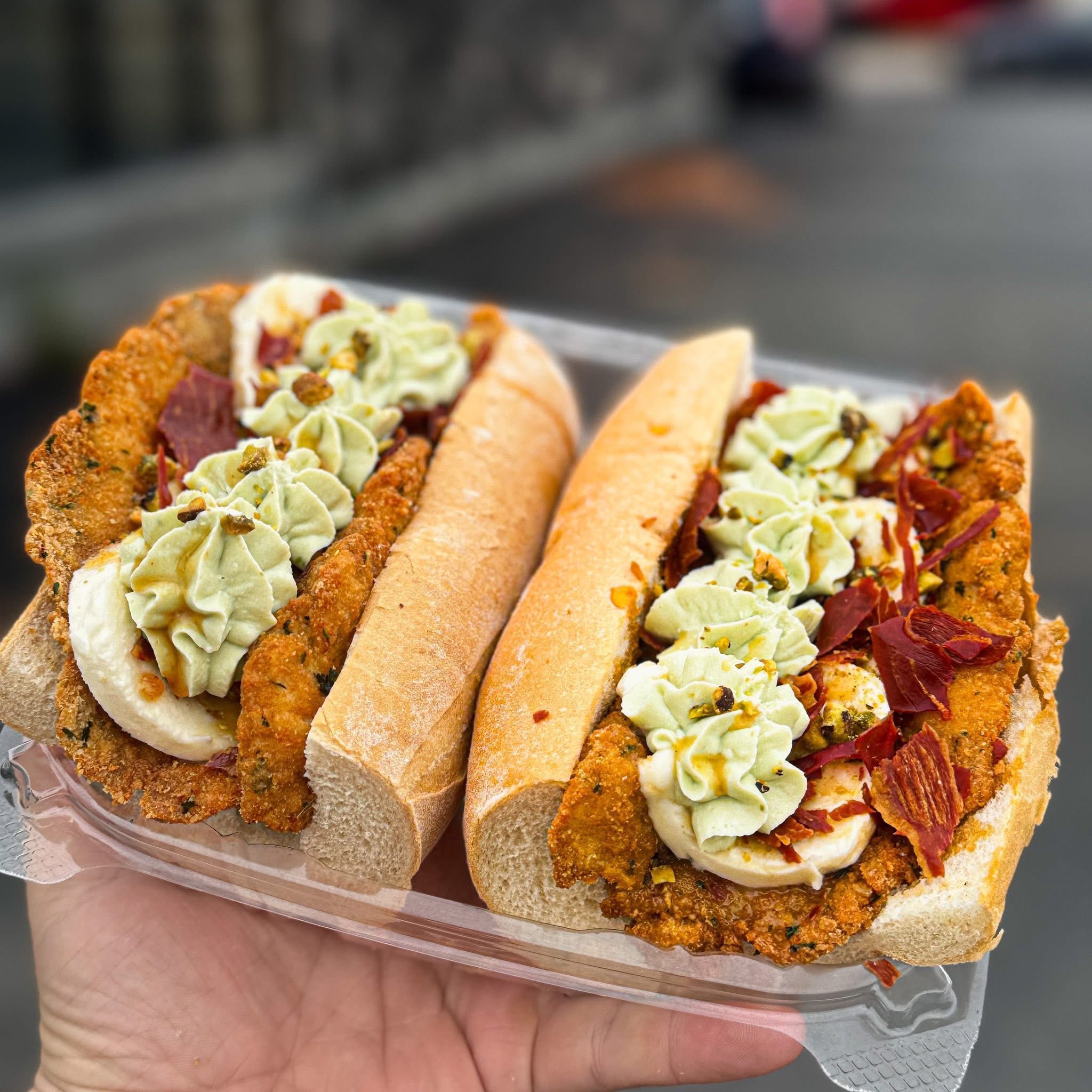 Italian baguette sandwiches with creamy filling and pistachio garnish